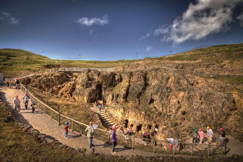 Tourists wearing hard hats queue at entrance to the Great Orme Copper Mines in Llandudno